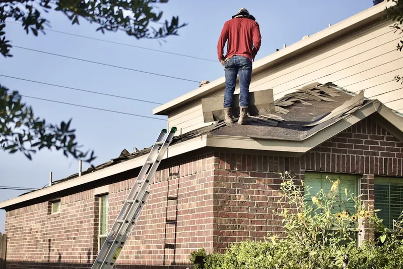 Professional roofer working on a residential roof in East Point